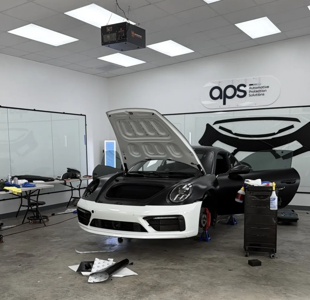 Porsche 911 full wrap color change in progress at APS Austin with pre-cut XPEL film panels