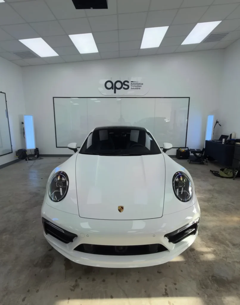 Porsche 911 in factory white before its full wrap color change at APS in Austin, TX