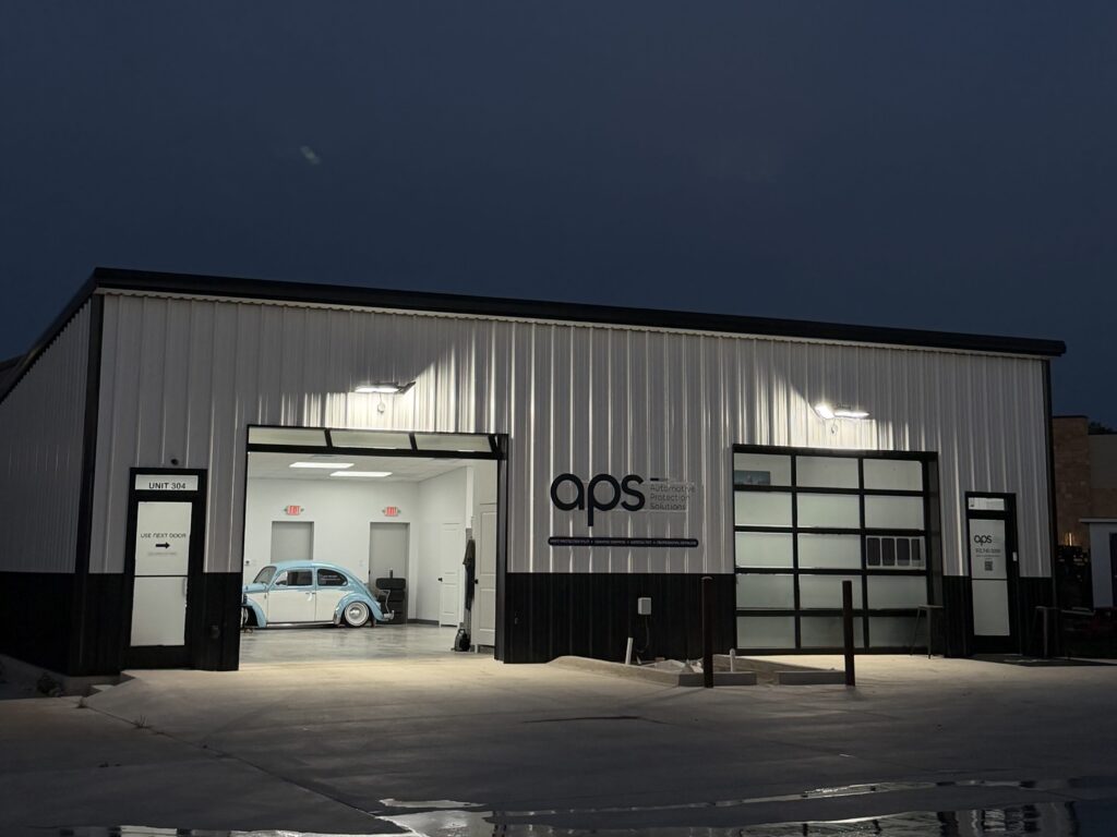 The APS shop in Southwest Austin at night with the bay door open