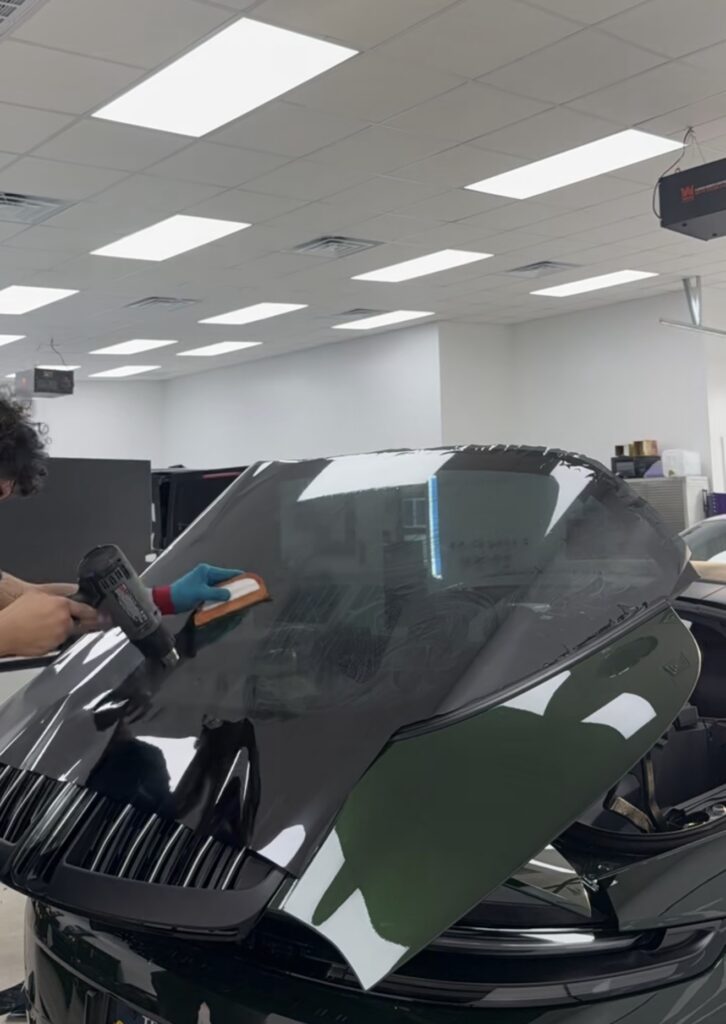 Installer heat-shrinking window tint film to the curved rear glass of a Porsche 911 Targa 4S in Austin, TX