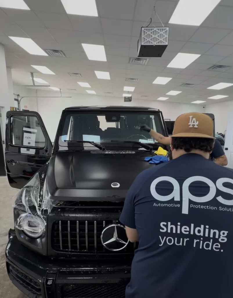 APS installer applying XPEL Stealth paint protection film to a G63 in Austin