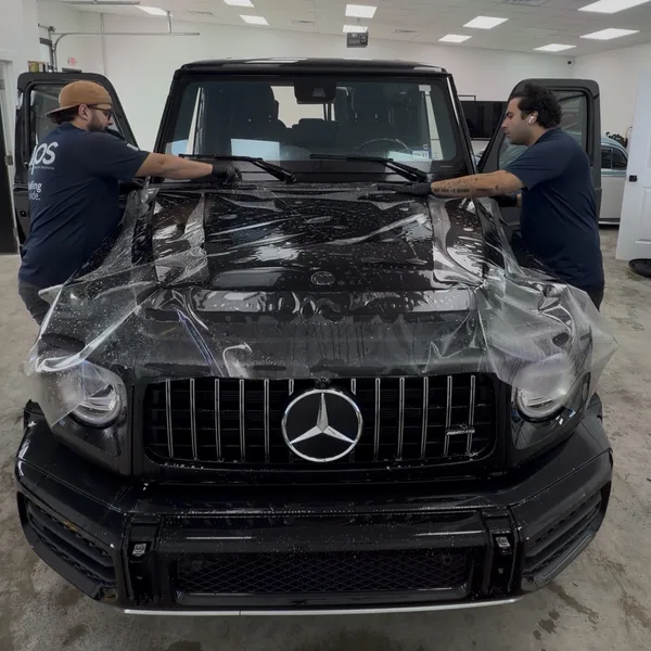 APS installers applying paint protection film to a Mercedes-AMG G63 in Austin, TX